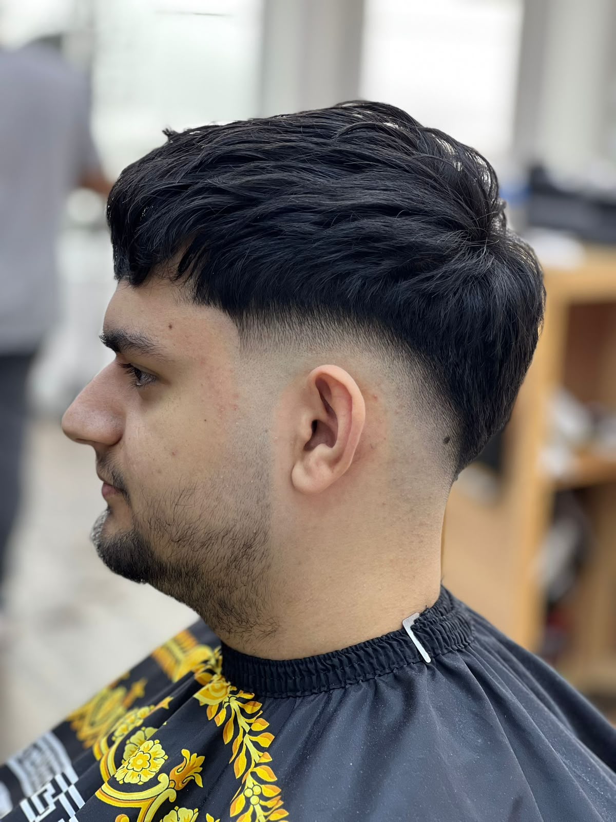 Low taper fade with textured fringe